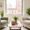 A warm, sunlit therapy office with two comfortable armchairs, plants, and soft textiles